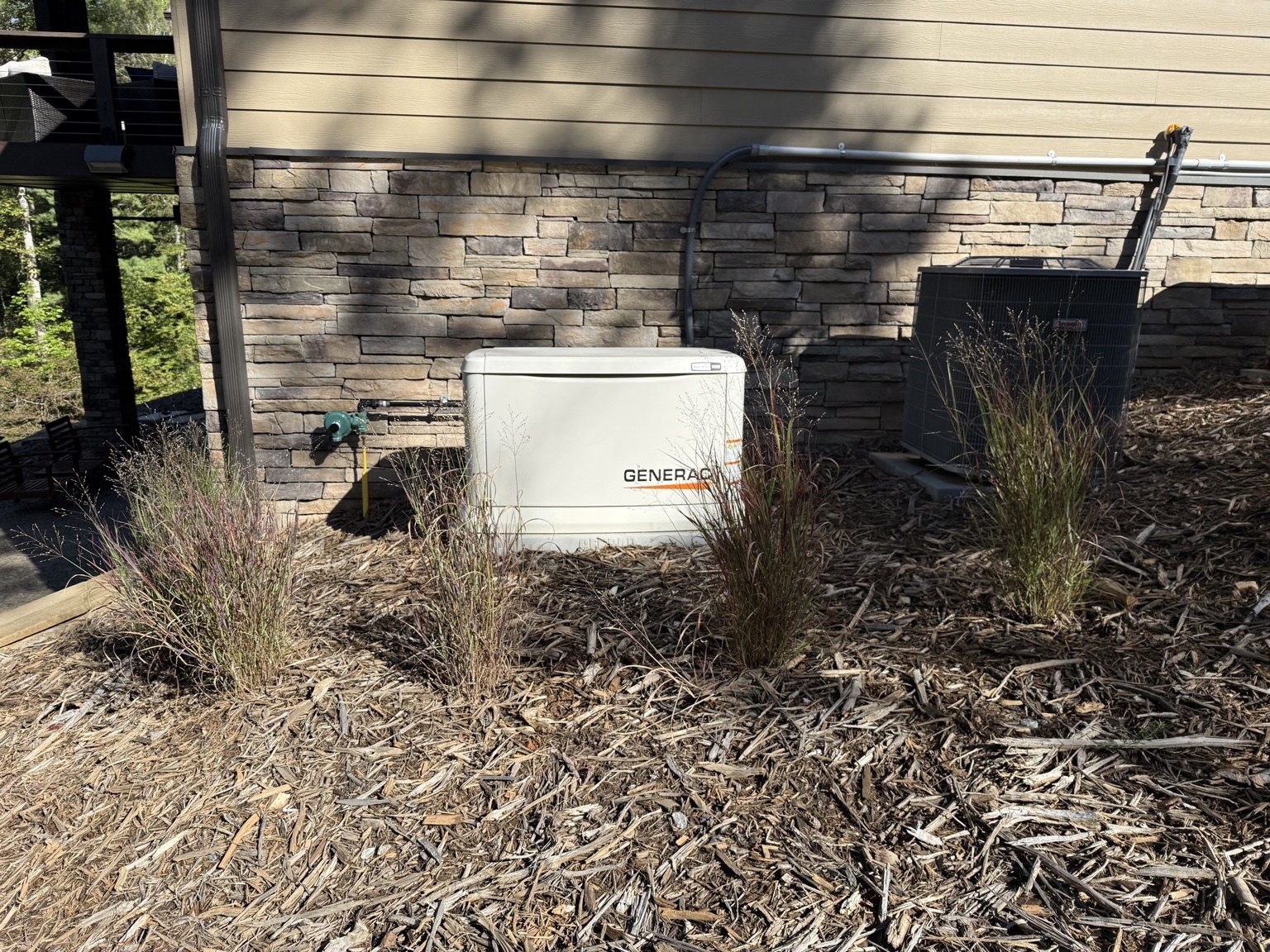 Generac standby generator installed beside a home
