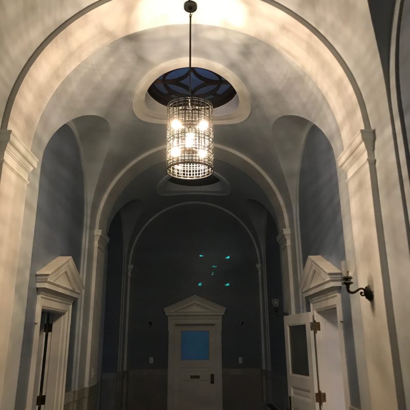 Hanging fixture illuminating an arched interior